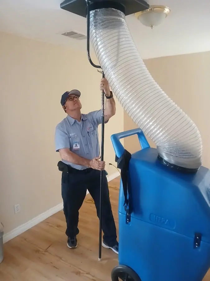 Furnace Tune-Up technician using HEPA equipment in Carrboro